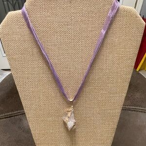 Lavender hued crystal on purple cord